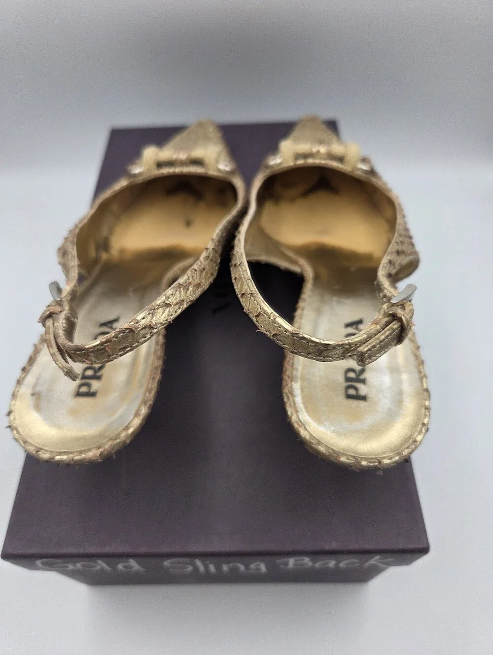 Pre- owned Prada snakeskin braided accents slingback pumps in a metallic gold